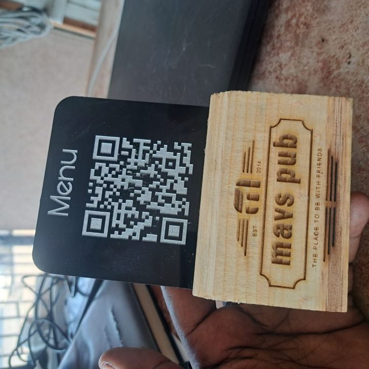 An engraved QR menu stand on a wooden base (placeholder photo)